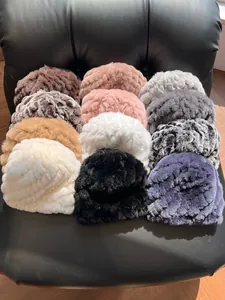 Flat lay of multiple Rex rabbit fur hats showing various colors and leopard patterns