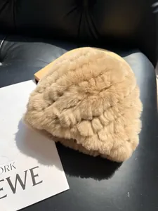 Detail of light camel plush winter hat showing thick striped faux rabbit fur texture