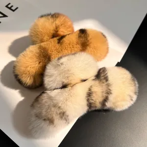 Detailed close-up showing soft animal print faux fur texture on large plush hair claw clips