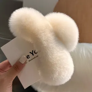 Detail view of large plush faux rabbit fur hair claw clip in soft creamy white color