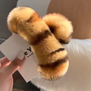 Detailed close-up of a large tiger-striped faux fur hair claw clip with soft plush texture