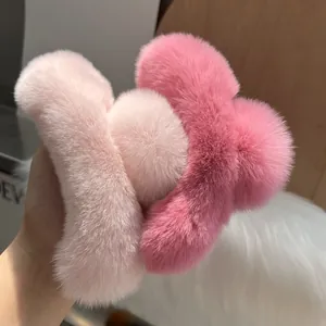 Detail shot of large fluffy pink faux rabbit fur hair claw clips with soft texture