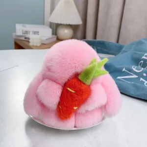 Détail d'un lapin en peluche rose avec un petit accessoire carotte orange mignon