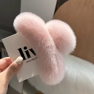 Detailed close-up of the soft pink plush hair claw clip featuring fluffy faux fur texture