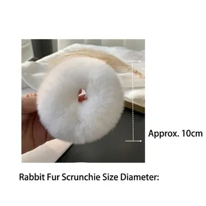Detailopname van een witte pluche haarelastiek met een diameter meting van circa 10 cm