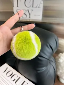 Close-up of fluffy faux rabbit fur tennis ball keychain with silver metal swivel clasp