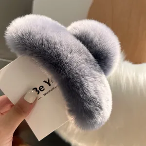 Detail shot of a large fluffy grey-purple rabbit fur hair claw clip for autumn and winter