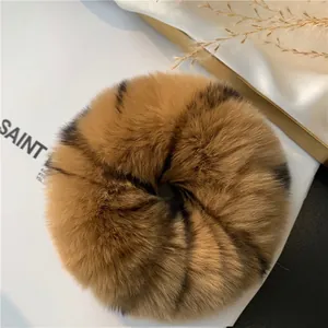 Macro detail of plush rex rabbit fur scrunchie with brown animal print texture