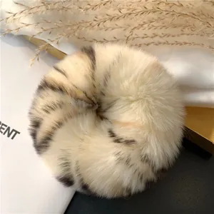 Detailed view of plush rex rabbit fur scrunchie with animal print and soft texture