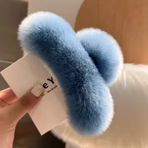 Close-up of light blue plush faux fur hair claw clip showing soft and fluffy texture