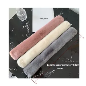 Detailed view of plush faux fur scarves in pink, cream and grey, length approx 58cm