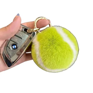 Fluorescent green plush tennis ball keychain with gold ring and soft faux rabbit fur