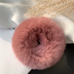 Detailed texture of fluffy dusty rose rex rabbit fur scrunchie for hair styling
