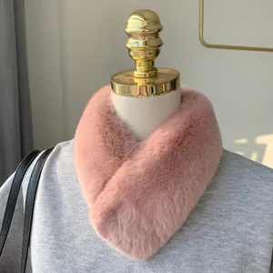 Detail view of pink faux rabbit fur scarf displayed on a mannequin for winter styling
