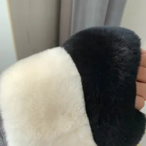 Detailed macro view of soft thick black and white faux rabbit fur scarf texture