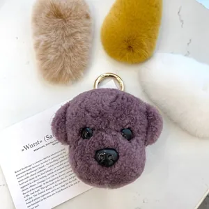 Detail view of colorful teddy dog plush keychains with premium gold metal ring clips