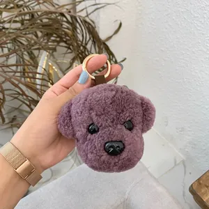 Handheld cute purple teddy dog plush keychain with golden ring and soft fur texture