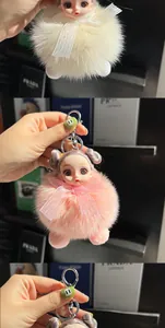 Detail of plush fox fur doll keychains with lace bows and stylish designer book props