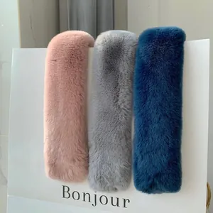 Detailed view of thick faux fur scarves in pink, grey and navy blue soft plush textures
