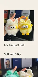 Close-up of plush fox fur coal ball keychain with colorful bows and cute eye details