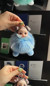 Detail of fox fur doll keychain showing blue and green plush textures and metal clasp
