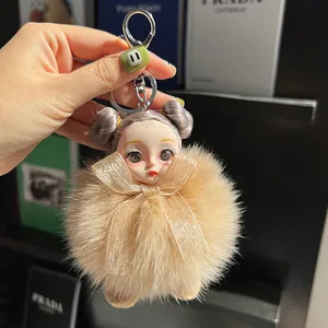 Cute doll head plush keychain with khaki fox fur pompom and purple bun hairstyle