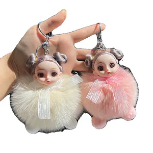 Cute fluffy fox fur doll keychains in cream and pink shown in hand with silver metal hooks