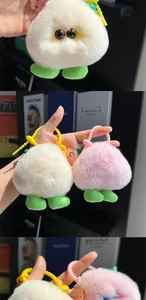 Detailed view of soft plush peach keychains in pink and white with candy hooks