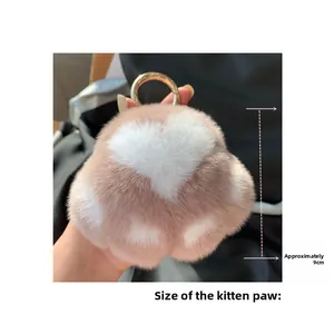 Detailed view of pink plush cat paw keychain with white heart and 9cm size marking