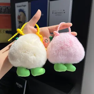 Plush peach keychain in pink and white faux fur with plastic handles and cute legs