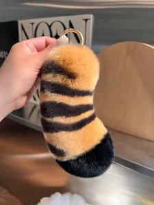 Cute fluffy tiger tail keychain made of real rex rabbit fur with a gold metal ring