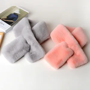 Detailed view of plush cross-style scarves in grey and pink with soft faux rabbit fur texture