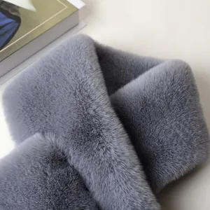 Close-up of thick grey faux rabbit fur scarf texture showing soft plush winter warmth