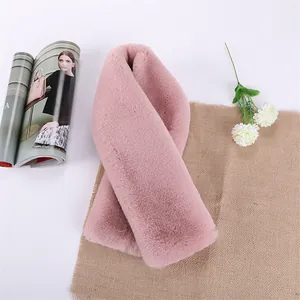 Close-up of soft pink faux rabbit fur scarf texture for winter warmth and comfort