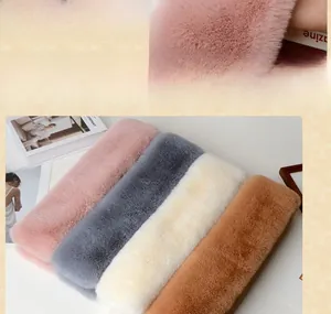 Close-up of soft faux rabbit fur scarves in pink, grey, beige and khaki colors