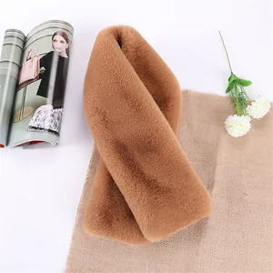 Detailed view of the dense faux rabbit fur scarf in caramel color with crossover design