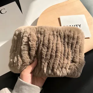 Detail of soft tan rabbit fur neck warmer with thick elastic ribbing and plush texture