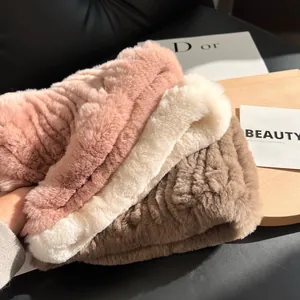 Detail of plush faux rabbit fur scarves in pink, white, and coffee colors with soft texture