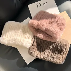 Detail of plush faux rabbit fur neck warmers in various colors with striped texture