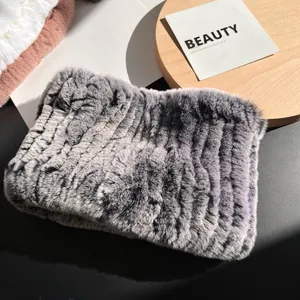 Detailed close-up of soft grey rex rabbit fur scarf texture on a decorative setup