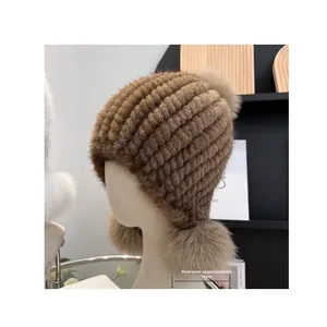 Detail view of winter mink fur hat featuring three fluffy 10cm pom-poms on ear flaps