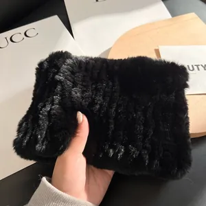 Detailed close-up of thick black rabbit fur scarf with soft ribbed texture and plush feel