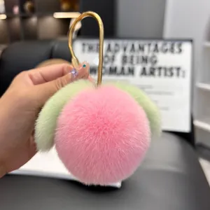 Cute pink faux rabbit fur peach keychain with green leaves and golden clip