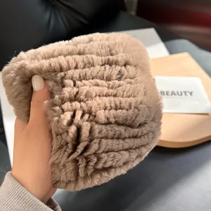 Close-up of thick light brown faux fur scarf showing soft plush texture and high density