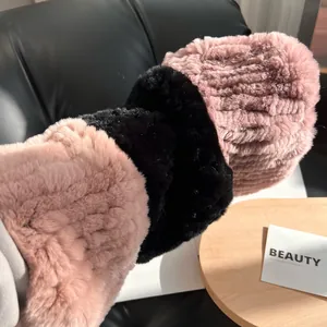 Three plush faux fur elastic hairbands in pink and black featuring pleated texture details
