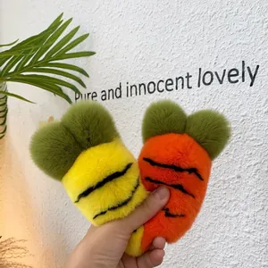 Detail of plush carrot charms in yellow and orange with soft faux rabbit fur texture