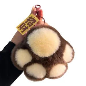Plush cat paw keychain in dark brown and beige faux fur with lucky charm tag