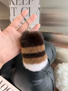 Detail of soft striped rex rabbit fur keychain with elegant metal clasp and strap