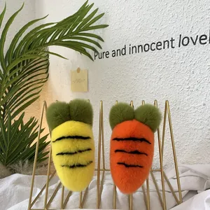 Detailed view of yellow and orange plush carrot charms on a metal stand for home decor