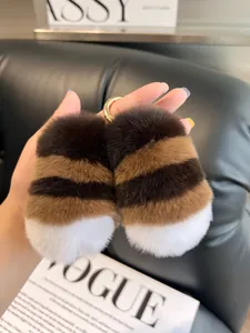 Close-up of striped rabbit fur keychains with gold metal rings against a Vogue magazine